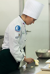 Image showing Girl-cook prepares food in competition