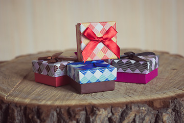 Image showing Gift box with red bow on wood background