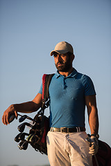 Image showing golfer  portrait at golf course on sunset