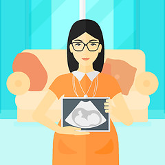 Image showing Pregnant woman with ultrasound image.