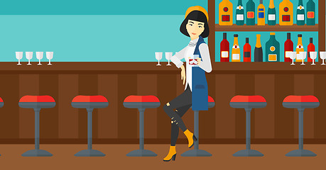 Image showing Woman sitting at bar.