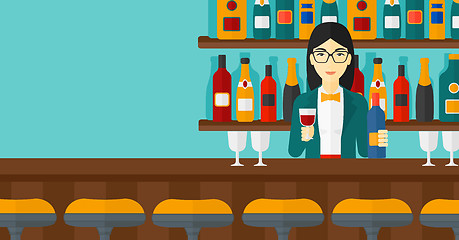 Image showing Bartender standing at the bar counter.