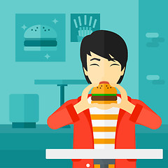 Image showing Man eating hamburger. 