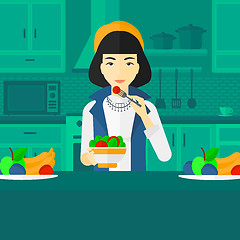 Image showing Woman eating salad.