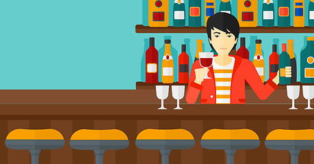 Image showing Bartender standing at the bar counter.