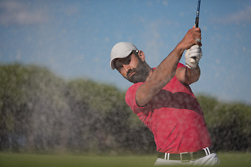 Image showing golfer hitting a sand bunker shot