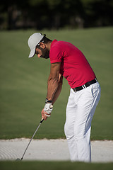 Image showing golfer hitting a sand bunker shot