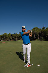 Image showing golf player hitting shot