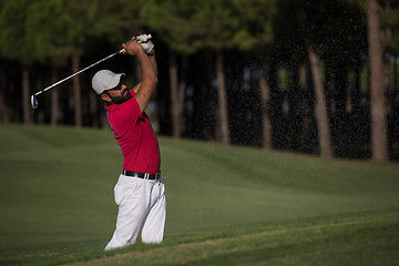 Image showing golfer hitting a sand bunker shot