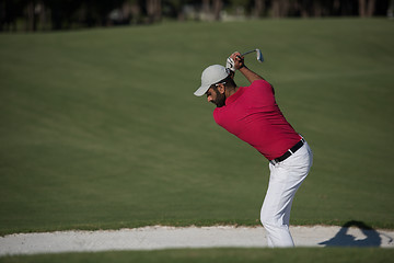 Image showing golfer hitting a sand bunker shot