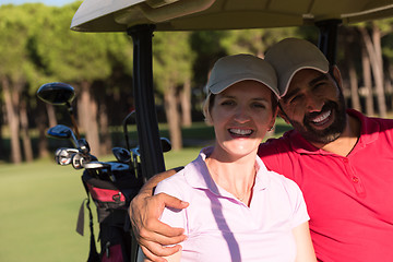 Image showing couple in buggy on golf course