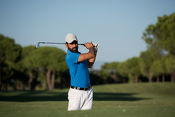 Image showing pro golfer hitting a sand bunker shot