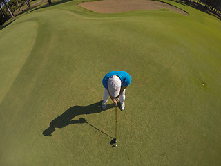 Image showing top view of golf player hitting shot