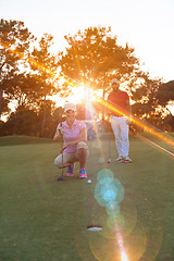 Image showing couple on golf course at sunset