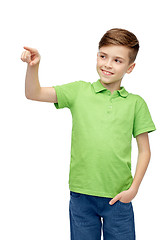 Image showing happy boy in green polo t-shirt pointing finger up