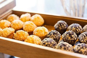 Image showing close up of sweets or muffins on wooden tray