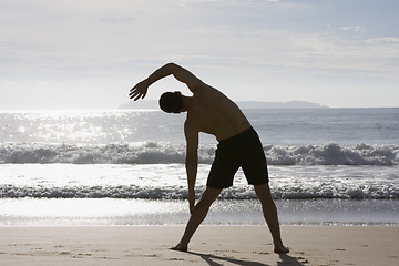 Image showing Man doing exercises on beach