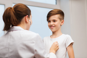 Image showing doctor with stethoscope listening to happy child