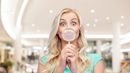 Image showing happy young woman with magnifying glass