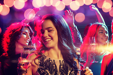 Image showing smiling friends with glasses of champagne in club