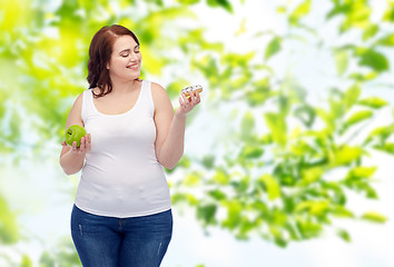 Image showing happy plus size woman choosing apple or donut