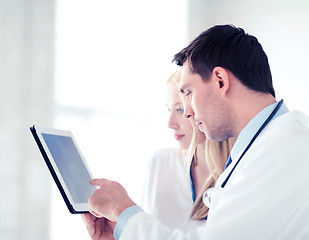 Image showing two doctors looking at x-ray on tablet pc