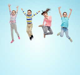 Image showing happy little children jumping in air over blue