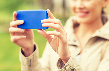 Image showing close up of woman taking picture with smartphone