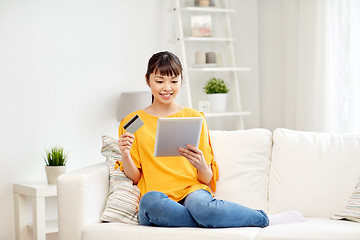 Image showing happy asian woman with tablet pc and credit card