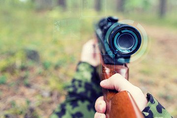 Image showing close up of soldier or sniper with gun in forest