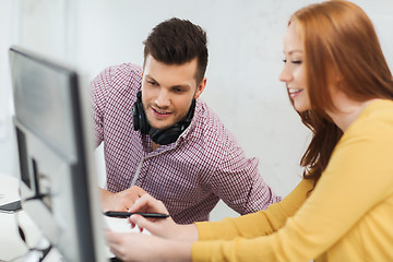 Image showing creative team with headphones and computer