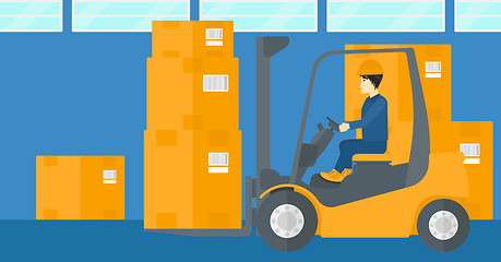 Image showing Warehouse worker moving load by forklift truck.