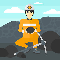 Image showing Miner holding coal in hands.