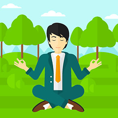 Image showing Businessman meditating in lotus pose.