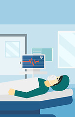 Image showing Patient lying in hospital bed with heart monitor.