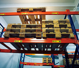 Image showing Shelves and racks with pallets in distribution warehouse interio