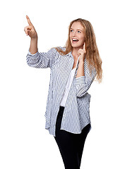 Image showing Happy excited woman pointing to the side
