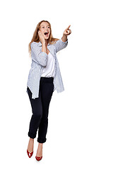 Image showing Happy excited woman in full length pointing to the side