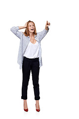 Image showing Happy excited woman in full length pointing to the side