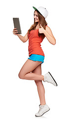 Image showing Full length sporty female with digital tablet