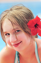 Image showing Portrait of a girl with red flower