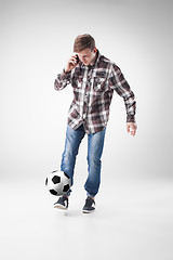 Image showing Portrait  of young man with smart phone and football ball