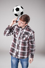 Image showing Portrait  of young man with smart phone and football ball