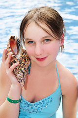 Image showing Young girl with seashell