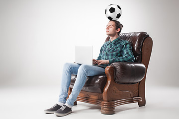 Image showing Portrait of young man with laptop and football ball