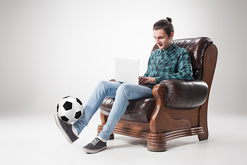 Image showing Portrait of young man with laptop and football ball