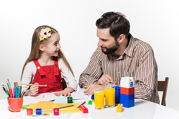 Image showing The daughter and father drawing together