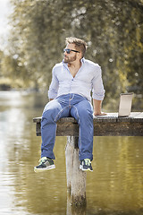 Image showing man at the lake with notebook