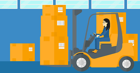 Image showing Warehouse worker moving load by forklift truck.