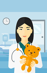 Image showing Pediatrician holding teddy bear.